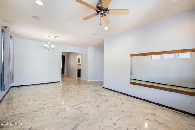 empty room with ceiling fan with notable chandelier