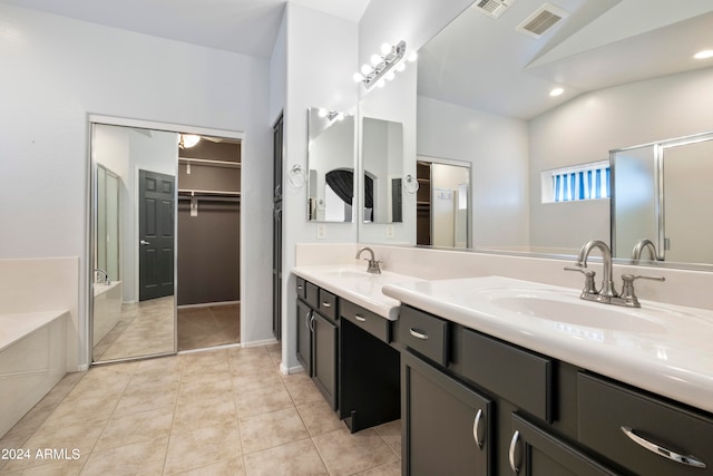 bathroom featuring vanity, tile patterned floors, and a washtub