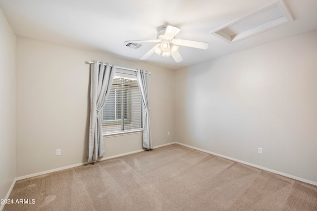 empty room with light colored carpet and ceiling fan