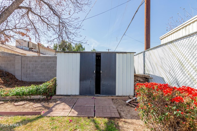 view of shed featuring fence