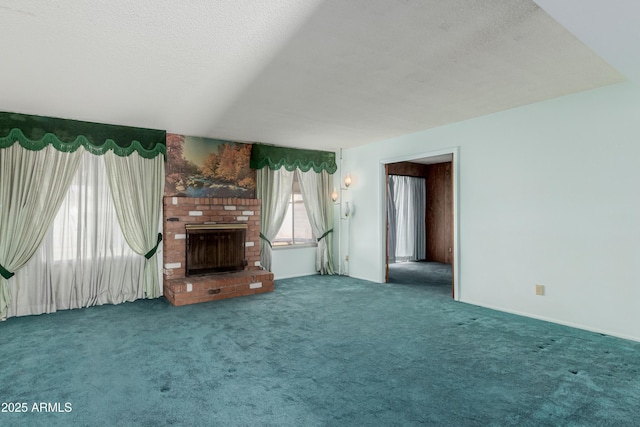 unfurnished living room with a fireplace, carpet floors, and a textured ceiling