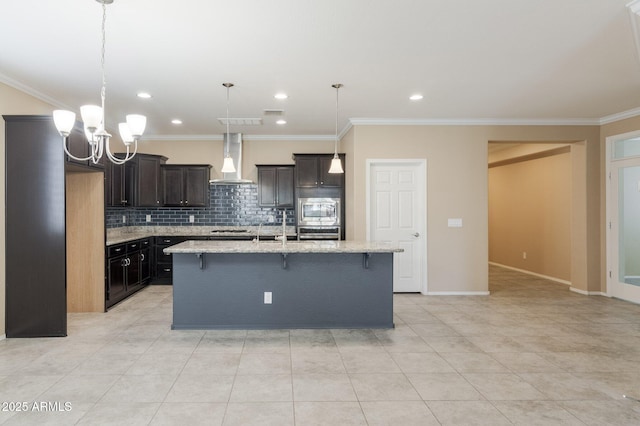 kitchen featuring hanging light fixtures, a kitchen breakfast bar, stainless steel appliances, an island with sink, and wall chimney exhaust hood