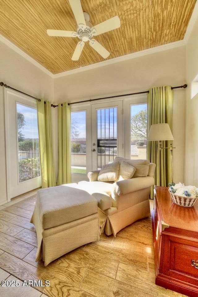 sunroom featuring wooden ceiling and a ceiling fan