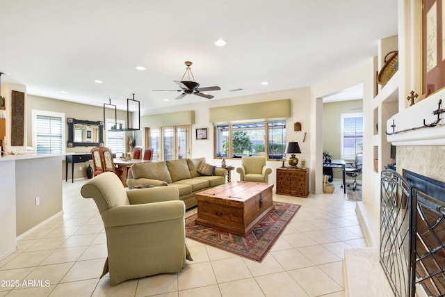 living room with light tile patterned floors, ceiling fan, a tiled fireplace, and recessed lighting