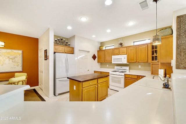 kitchen featuring white appliances, glass insert cabinets, pendant lighting, a sink, and light tile patterned flooring