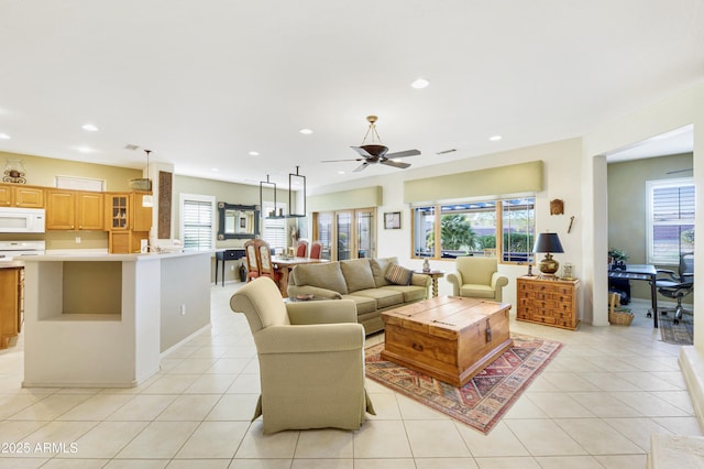 living room with light tile patterned floors, ceiling fan, visible vents, and recessed lighting