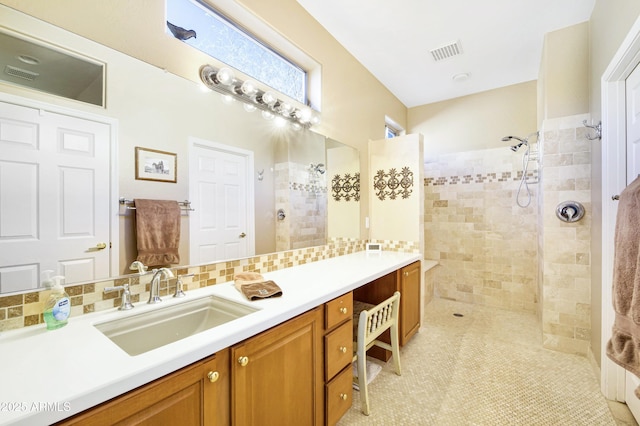 bathroom featuring walk in shower, visible vents, decorative backsplash, and vanity