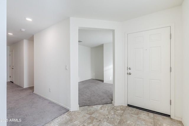 entryway featuring light colored carpet