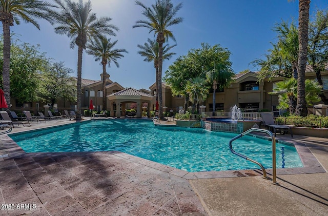 community pool featuring a patio area and fence