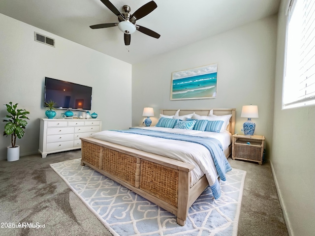 bedroom with carpet floors, visible vents, ceiling fan, and baseboards