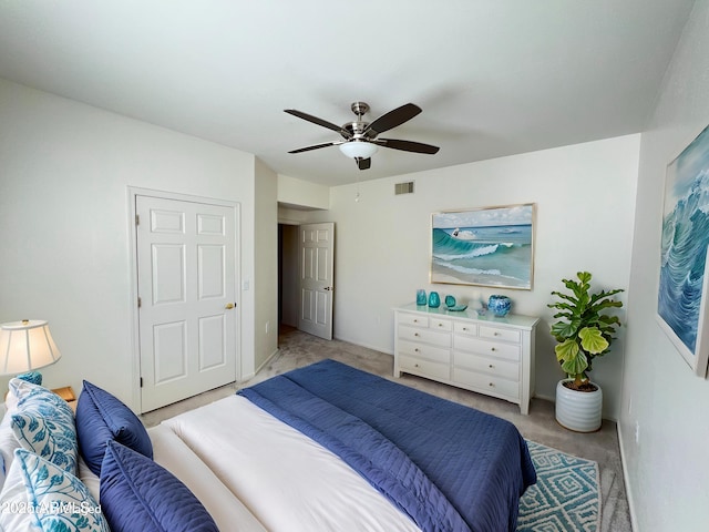 bedroom featuring light carpet, ceiling fan, and visible vents