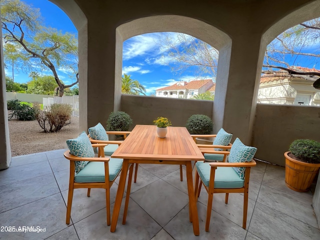 view of patio featuring outdoor dining area and a balcony