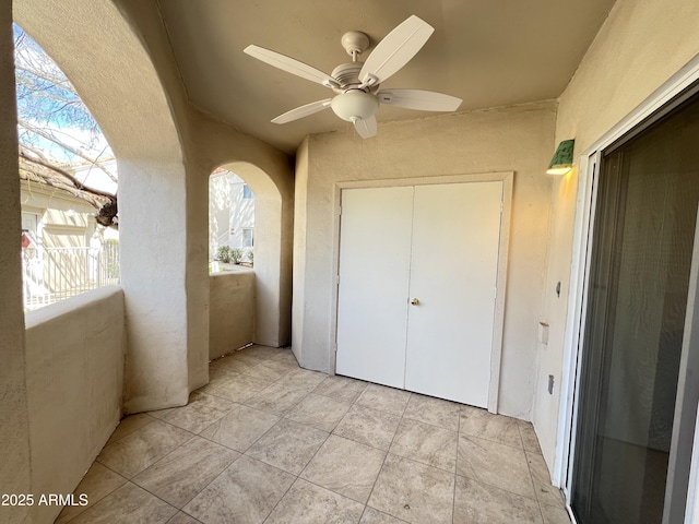 exterior space featuring a closet and ceiling fan