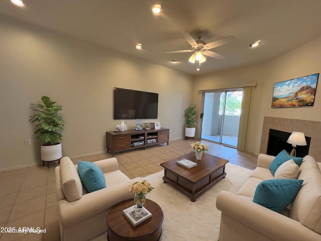 living room featuring light tile patterned floors, ceiling fan, a tiled fireplace, and recessed lighting