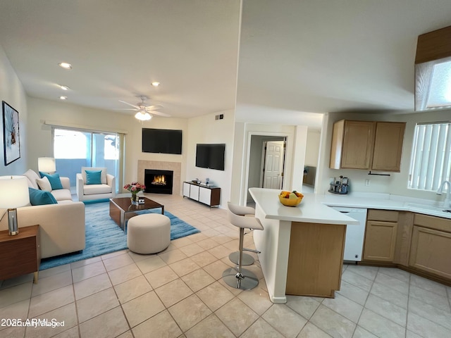 kitchen with open floor plan, light countertops, white dishwasher, and light tile patterned flooring