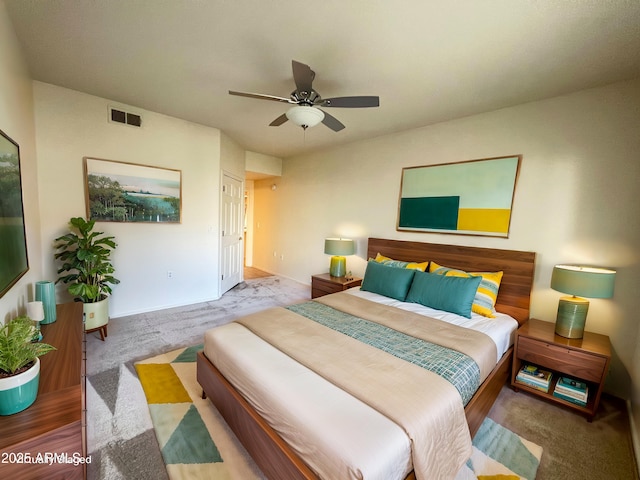 bedroom with carpet, visible vents, and ceiling fan