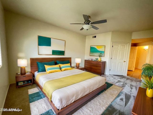 carpeted bedroom featuring ceiling fan and visible vents