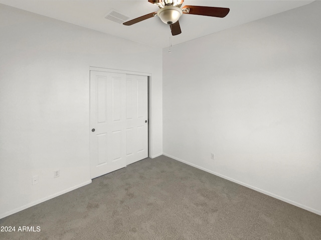 unfurnished bedroom featuring a closet, carpet, and ceiling fan