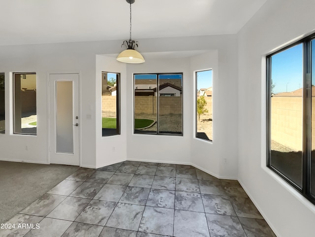 unfurnished dining area featuring carpet