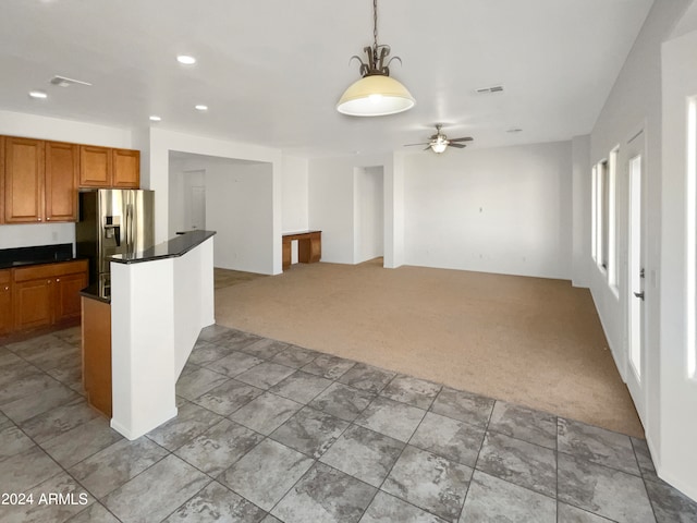 kitchen featuring light carpet, stainless steel refrigerator with ice dispenser, decorative light fixtures, and ceiling fan