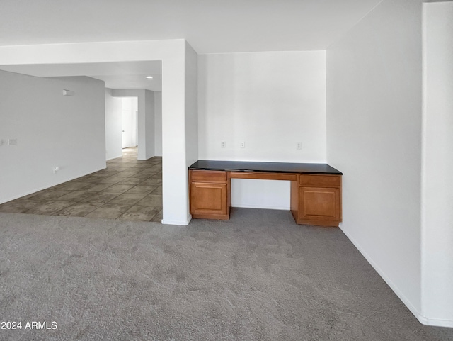 interior space with built in desk and carpet floors