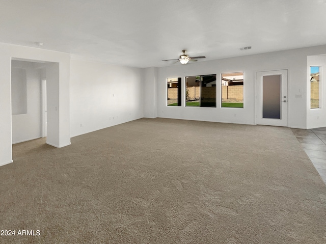 unfurnished living room with carpet floors and ceiling fan