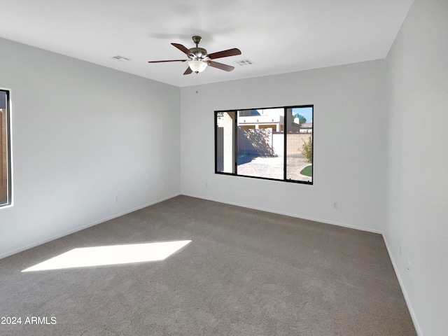 spare room with carpet flooring and ceiling fan