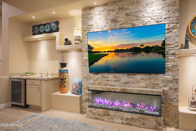 interior space with a fireplace, vanity, and wine cooler