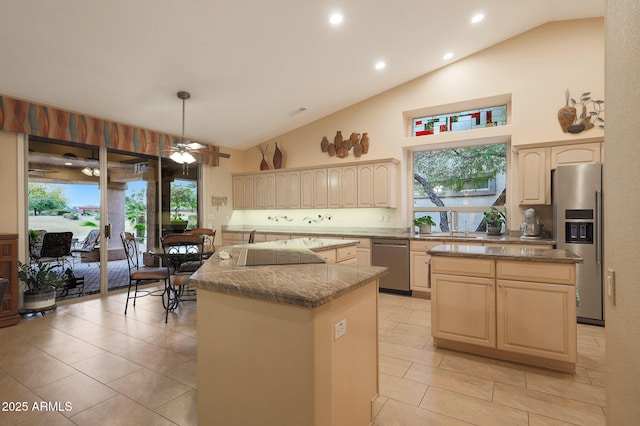 kitchen with appliances with stainless steel finishes, a kitchen island, pendant lighting, and light tile patterned flooring