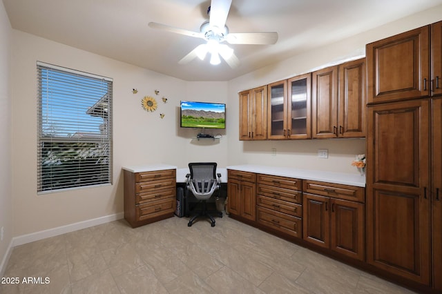 office featuring ceiling fan and built in desk