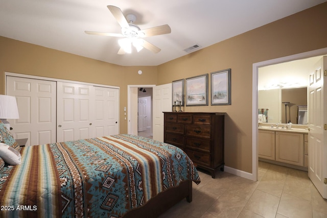 tiled bedroom with a closet, ensuite bathroom, and ceiling fan