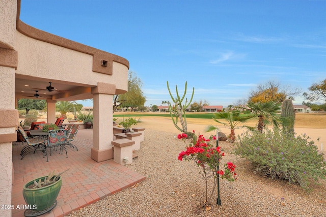 exterior space with ceiling fan