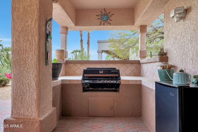 view of patio featuring area for grilling and exterior kitchen