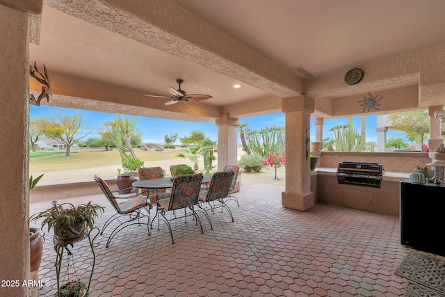 view of patio / terrace featuring ceiling fan, exterior kitchen, and grilling area