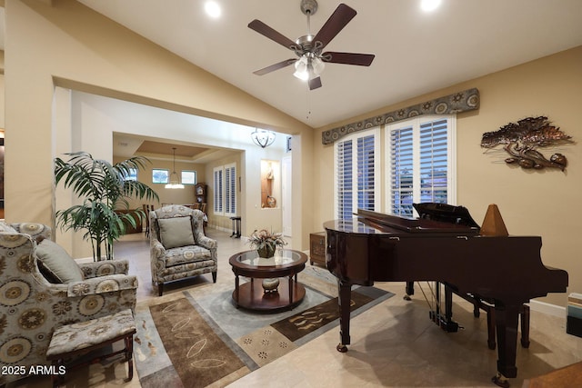 living area featuring ceiling fan with notable chandelier and vaulted ceiling