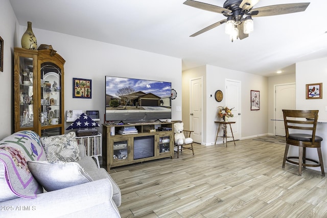 living room featuring ceiling fan and light wood-type flooring