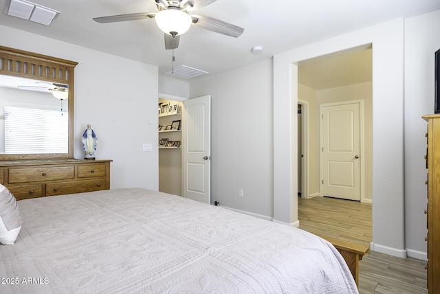 bedroom with ceiling fan and light wood-type flooring