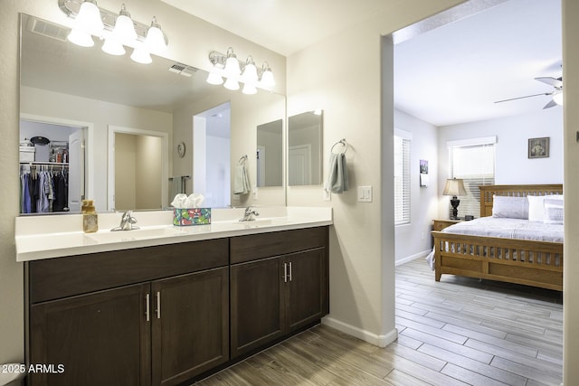 bathroom with ceiling fan, wood-type flooring, and vanity