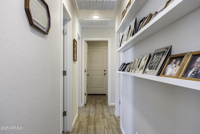 corridor with light hardwood / wood-style floors