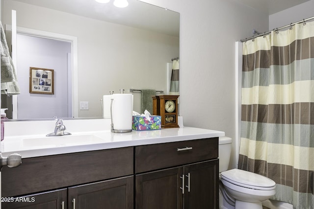 bathroom featuring vanity, curtained shower, and toilet