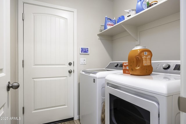 washroom with washing machine and clothes dryer