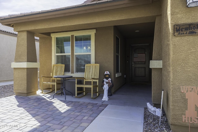 entrance to property with a patio