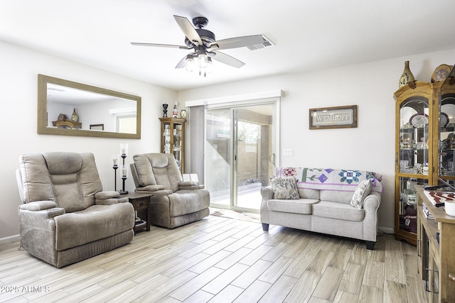 living room featuring light hardwood / wood-style flooring and ceiling fan