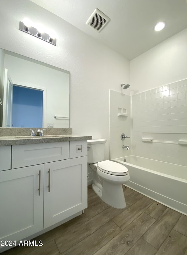 full bathroom with vanity, wood-type flooring, toilet, and tub / shower combination