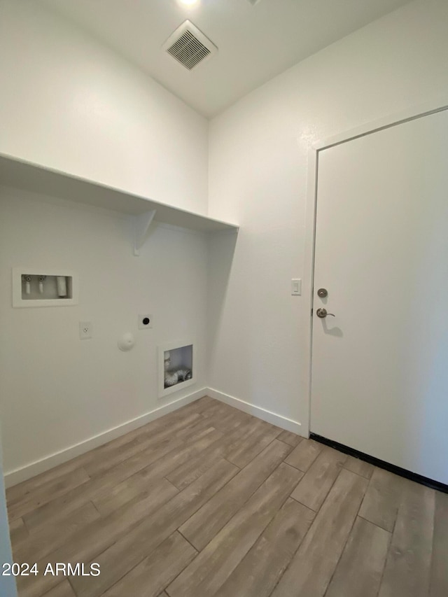 laundry room with electric dryer hookup, washer hookup, light hardwood / wood-style flooring, and hookup for a gas dryer