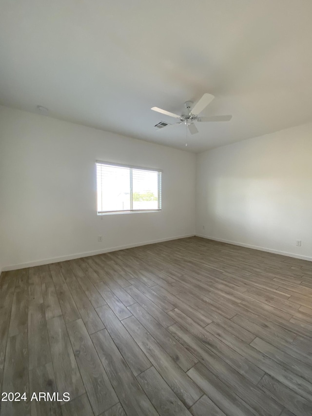 spare room with light hardwood / wood-style floors and ceiling fan