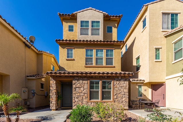 mediterranean / spanish-style home with a patio area