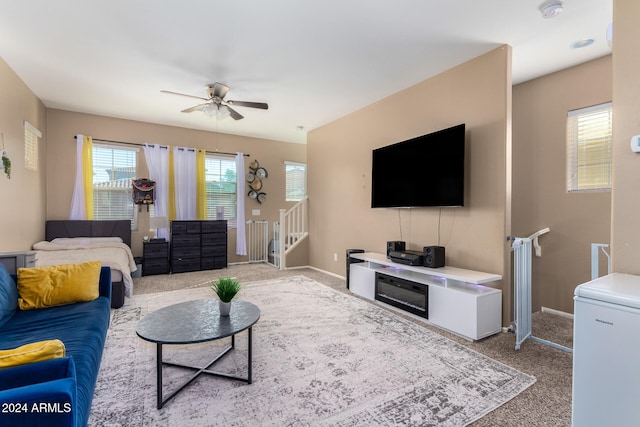 living room featuring light colored carpet and ceiling fan