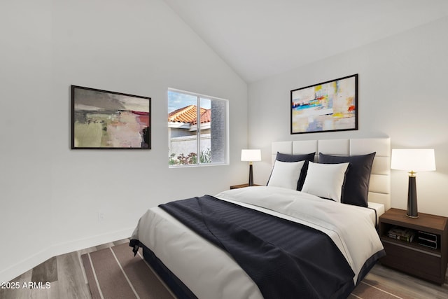 bedroom with wood-type flooring and high vaulted ceiling