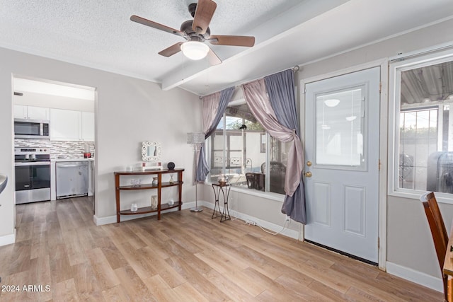 foyer featuring beamed ceiling, a textured ceiling, light hardwood / wood-style flooring, and ceiling fan